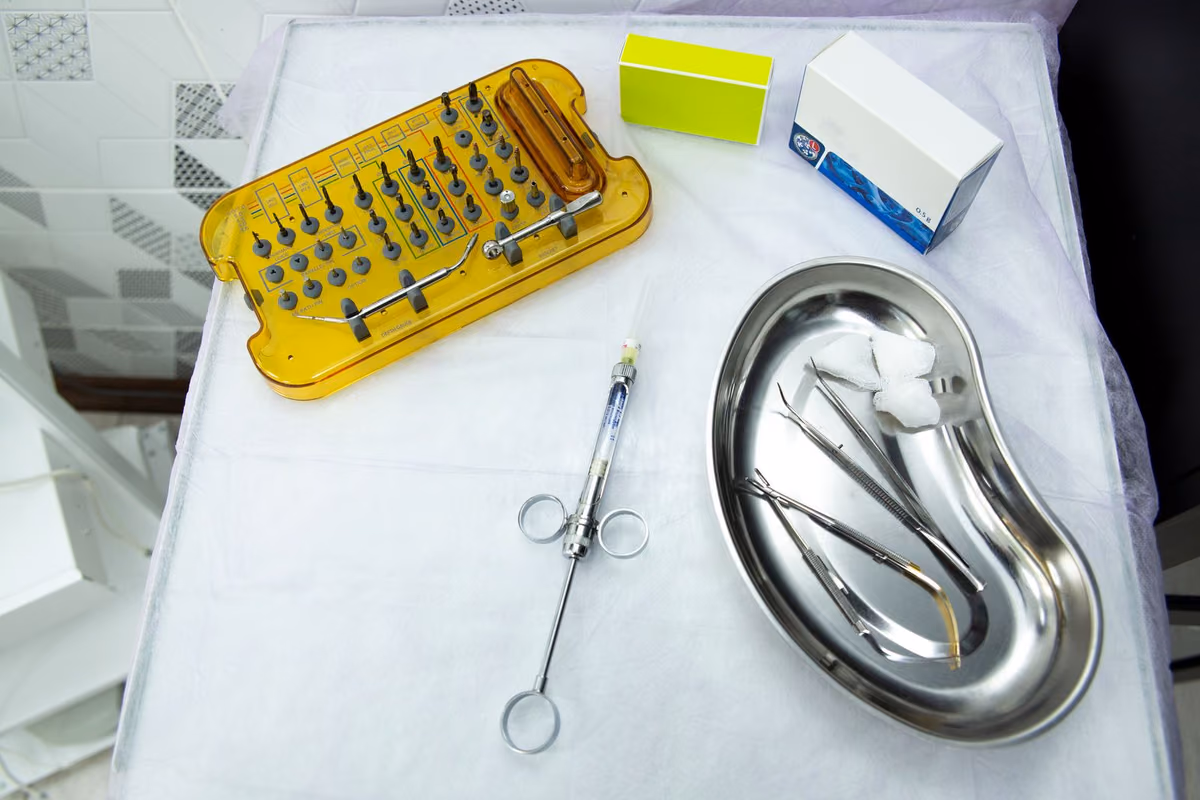 Sterile surgical instruments and supplies arranged on a clinical table, the setting for reviewing a bone graft that is not healing as expected.