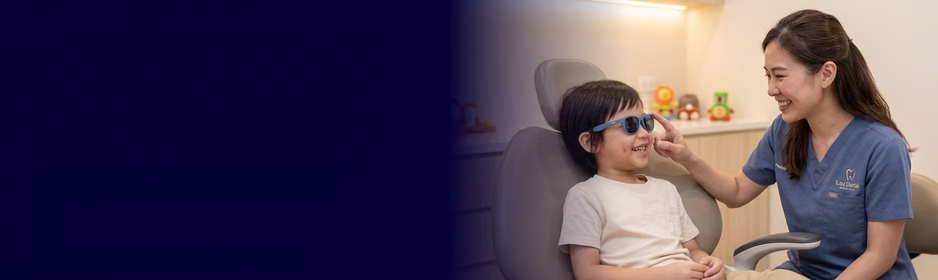 A cheerful young child smiling broadly while sitting comfortably in a modern pediatric dental clinic setting.